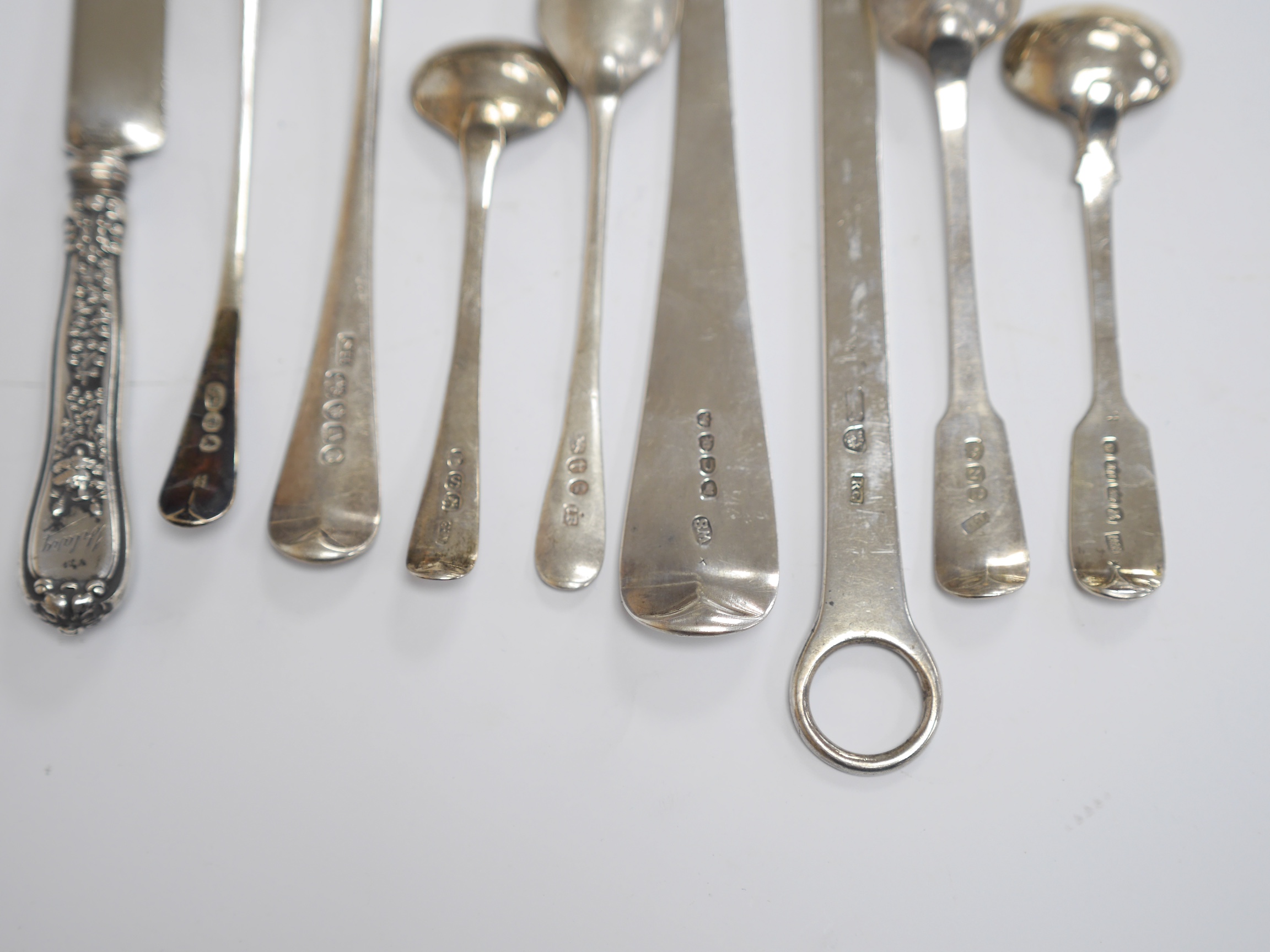 A George III silver Old English pattern basting spoon, by William Seaman, London, 1815, 31.6cm, together with a George III silver meat skewer, maker RS and six other items of silver flatware including a George III silver